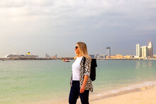 Girl In Stylish Clothes Walks Along The Dubai Beach