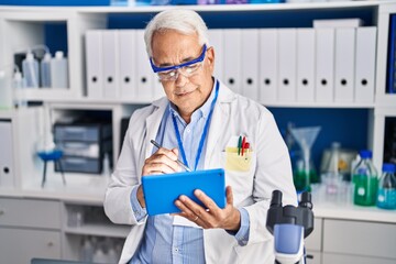 Poster - Senior man scientist using touchpad working at laboratory