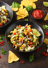 Mexican style salad of black beans, lentils, corn, tomato and lettuce with a salsa and tortilla chips