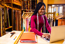 Dark Skinned Business Woman Salewoman Working At Textile Shop