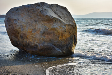 Wall Mural - A huge round rock on the sand by the sea in Izmir Seferihisar, Turkiye