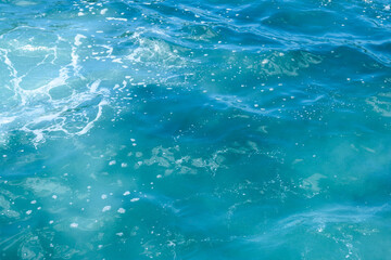 Natural background of blue foaming sea water