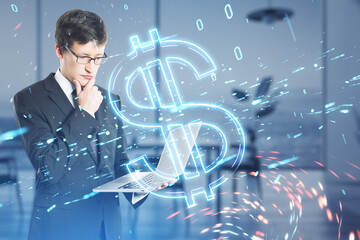 Aufkleber - Attractive young caucasian businessman using laptop with digital dollar hologram on blurry office interior background. Trade, finance and money concept. Double exposure.