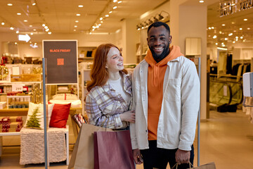 Canvas Print - funny laughing man and woman having fun at supermarket, happiness, funny prizes. close up portrait.