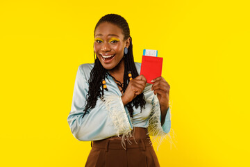 Wall Mural - Joyful African Lady Holding Passport And Tickets On Yellow Background