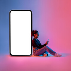 Poster - Black woman sitting next to huge smartphone with blank screen, advertising new mobile app or website, neon light