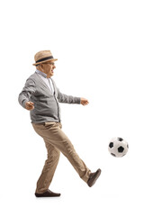 Sticker - Full length profile shot of an excited elderly man kiciking a football