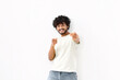 © kucherav - Lifestyle concept. Cheerful Indian young man in a white t-shirt fun pointing his fingers at the camera white background with copy space. Victory, celebrate triumph
