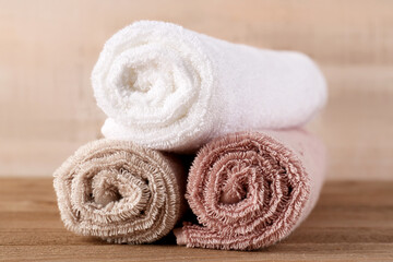 Wall Mural - Rolled soft towels on wooden table