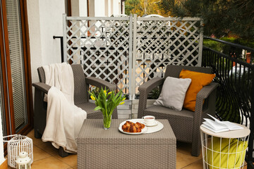 Canvas Print - Different pillows, blanket, breakfast and beautiful tulips on rattan garden furniture outdoors