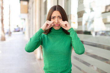 Wall Mural - young pretty woman looking desperate and frustrated, stressed, unhappy and annoyed, shouting and screaming