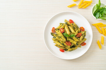 Wall Mural - penne pasta with pesto sauce and tomatoes