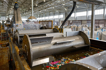 Wall Mural - Automatic shredded plastic washing machine. Washing in a bath of water using special paddle mixers.