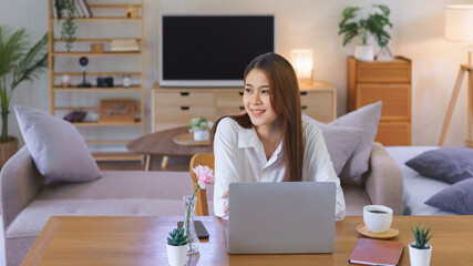 Wall Mural - Relaxing time concept, Women thinking and looking outside while working at modern home office