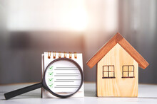 Home Inspections, Standards According To The Requirements,  Certifications, And Real Estate Safety. Wooden House And Magnifying Glass With A Checklist For Home With Copy Space