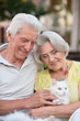 © aletia2011 - elderly couple holds a cat in their arms in the summer