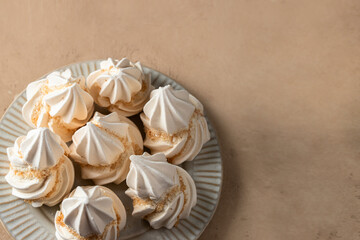 Wall Mural - Sweet Meringue on the plate on beige background.