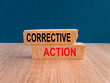 Corrective action symbol. Brick blocks with words 'Corrective action' on beautiful blue background, wooden table. Business and Corrective action concept. Copy space.
