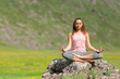 © Antonioguillem - Yogi doing yoga on a rock in the mountain