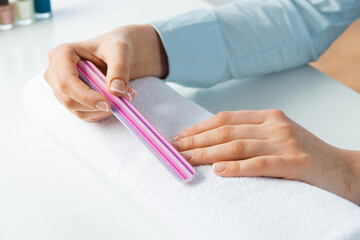 Wall Mural - Woman using nail file and create nails shape