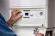 © Brian Jackson - Plumber technician servicing or repairing home heating system boiler