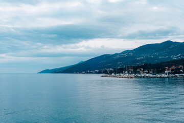 Wall Mural - Seafront of Opatija town, Croatia. Beautiful view of the mountains on the background