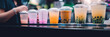 Bubble tea cups with tapioca boba in a bubble tea shop, blurred background, wide
