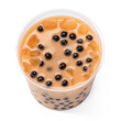 Cup of bubble tea with tapioca boba and milk, top down view, isolated, white background