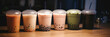 Bubble tea cups in a bubble tea shop, blurred background, wide