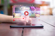 © panuwat - live video content online streaming marketing concept.close-up of Hands holding mobile phone