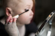 © Astrakan Images - Disabled young woman doing make-up