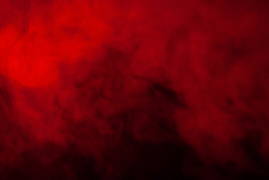 eerie black background with billowing red smoke