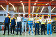 © AU USAnakul+ - Portrait of smiling group of diverse corporate colleagues standing with makes thumb up gesture in row together at the modern metalwork warehouse factory. Metal Sheet Roofing forming machine. Like