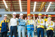 © AU USAnakul+ - Portrait of smiling group of diverse corporate colleagues standing with makes thumb up gesture in row together at the modern metalwork warehouse factory. Metal Sheet Roofing forming machine. Like