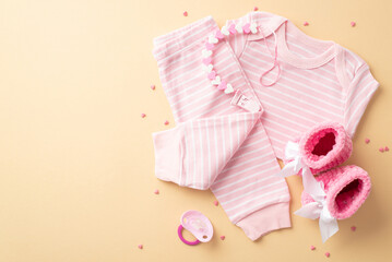 Wall Mural - Baby girl concept. Top view photo of infant clothes pink shirt pants knitted booties dummy teether chain and sprinkles on isolated pastel yellow background with empty space