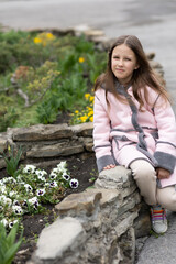 Wall Mural - a girl child  on a walk in the spring