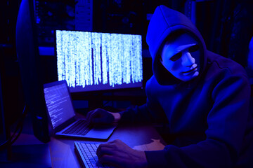 Canvas Print - Hacker in mask working with computers in dark room. Cyber attack