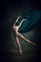 Wall Mural - Shot of one adorable ballerina dancing with elegance hands and silk fabric over dark green background