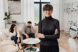 © Drobot Dean - Female psychologist standing in her office with married couple on the background