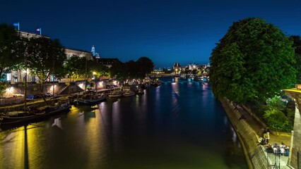 Poster - Aerial view to Pont des Arts in Paris after sunset day to night transition timelapse from Pont Neuf, France. Ship on the River Seine near square of the Vert-Galant. Reflection on water