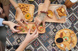 © DragonImages - Hands of people taking snacks from wooden plates view from above