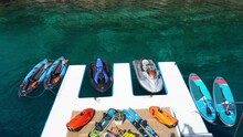 Jetskis With Watersports Equipment Moored On Floating Dock 