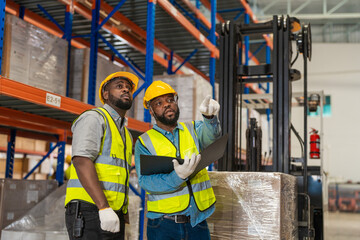 African workers holding folders for checking and inspecting on site warehouse area for shipping transportation. Concept people operation in heavy industrial.