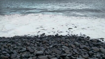 Wall Mural - Rocky beach coast. Rest on the sea. The wave washes the stones