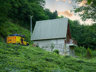 Mountain hut and campervan. Small house in green nature.