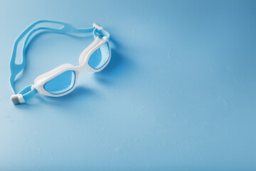 White swimming glasses with a blue lens