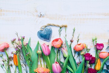 Wall Mural - Beautiful bouquet of spring flowers with heart on rustic wooden board - Greeting card for mothers day, birthday,  and wedding - season background