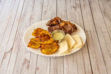 Wall Mural - A Latin American recipe for beef steak with hand cheese and patacones with sauce