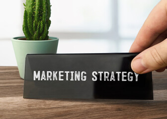 Poster - Text Marketing Strategy writen on black table card