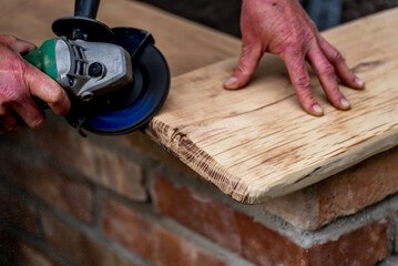 A carpenter works in a garden.